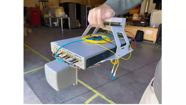 Software defined radio sensing payload, housed in a grey box with a connecting chassis, for use with an Orion drone